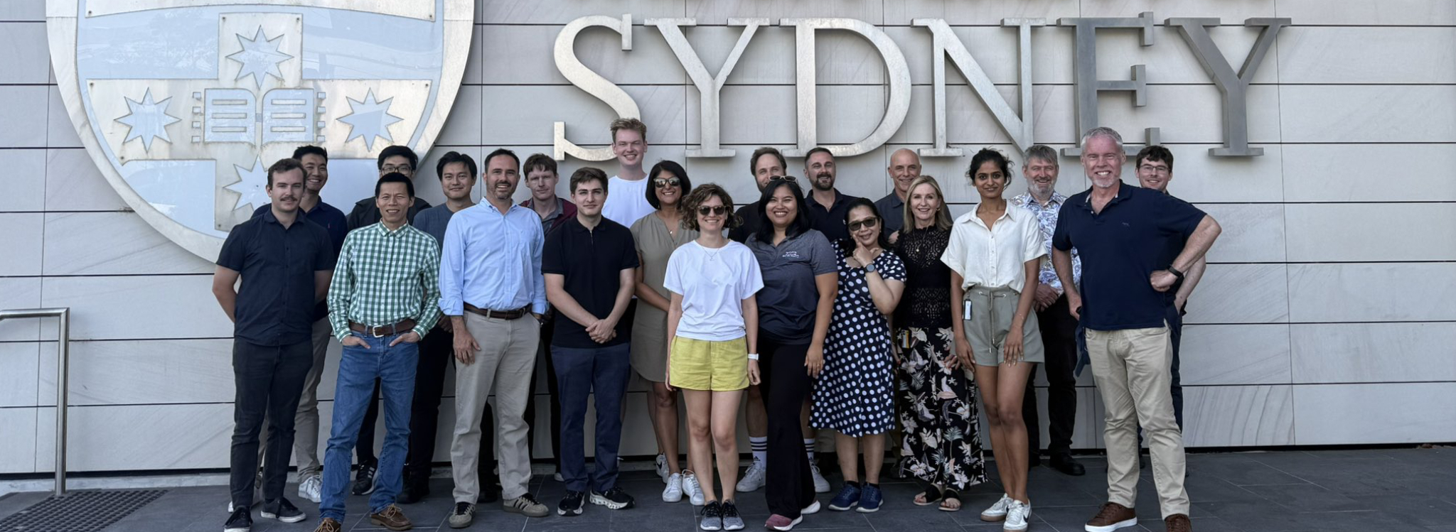 The 2025 Eggleton Research Group standing in front of a sign that says 'The University of Sydney'