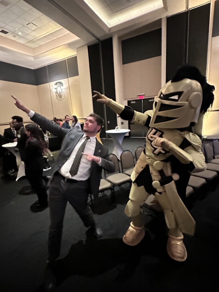 Jacob posing with the University of Central Florida Football Team Mascot